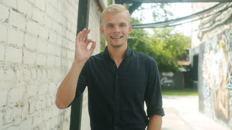 young man smiling in an urban setting
