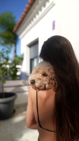 woman hugging a poodle outdoors