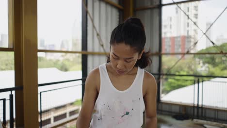 close-up of a female artist focused on her work