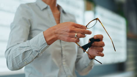 woman cleaning eyeglasses with a cleaning cloth