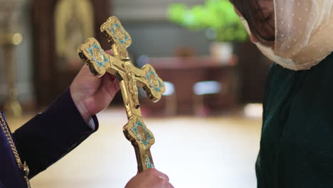 priest holding holy cross