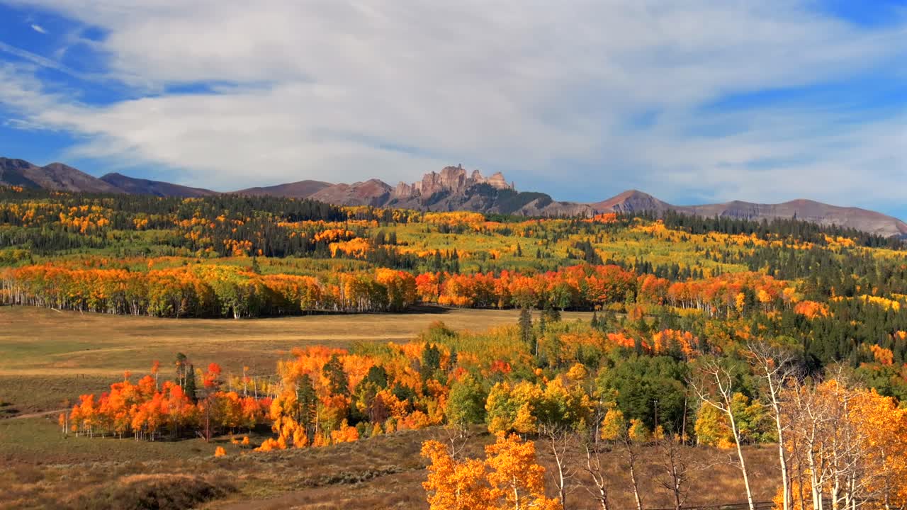 Crested Butte Ohio Kebler Pass Colorado aerial drone parallax The Castle Mountain Mill rock Castle Gunnison National Forest morning autumn fall Aspen tree colors blue sky cloud farmland circle right