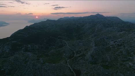 aerial shot high over the imposing biokovo mountain range in croatia near sunset