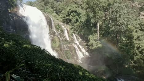 panning right to the majestic siriphum waterfall with rainbow forming in the mist, doi inthanon national park in chiang mai thailand