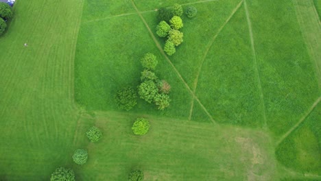 Backward-drone-shot-over-luxuriant-green-Phoenix-Park-in-Dublin,-Ireland