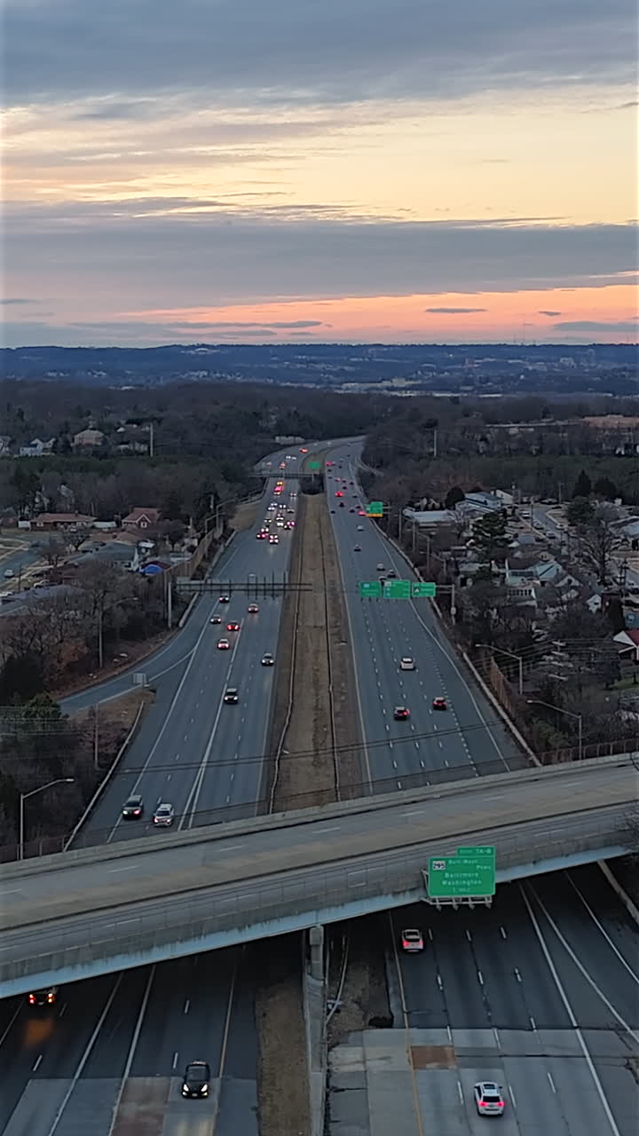 Above View Of Traffic Flowing Over Multi-lane Highway Interchange At Sunset. Timelapse