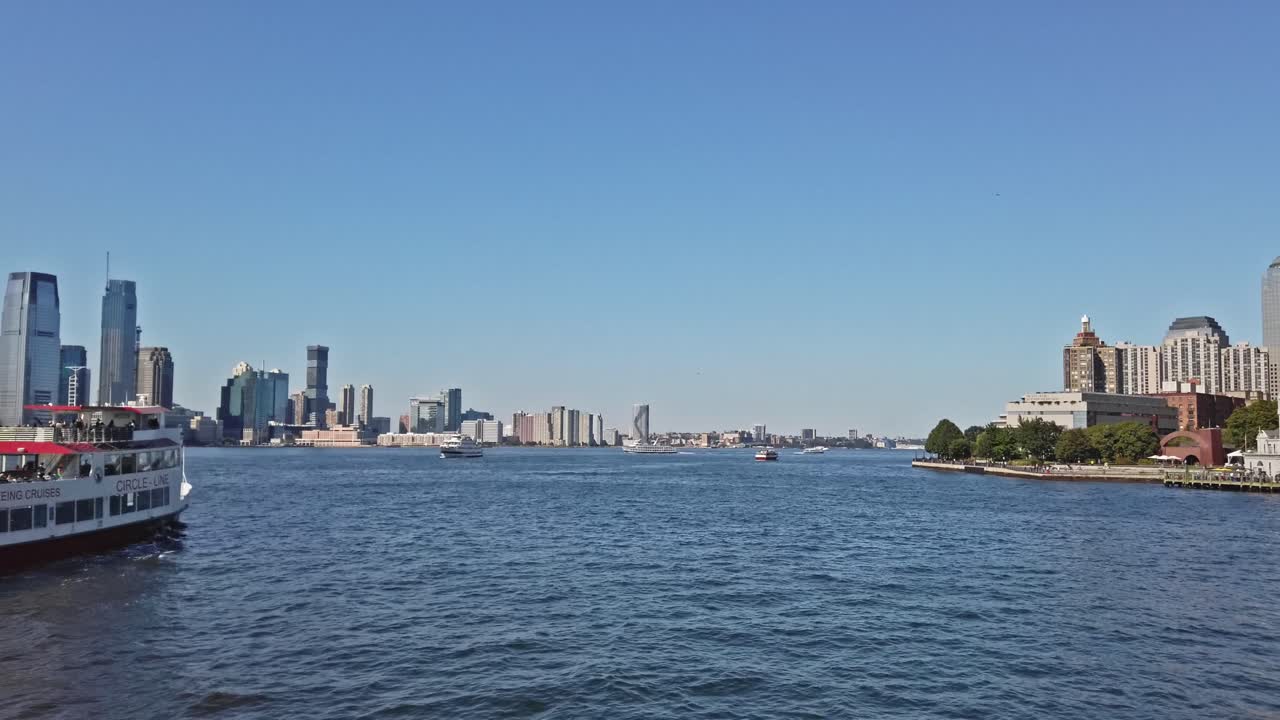 Battery park and Jersey city view from above in New York. Cinematic shot from Hudson river in sunlight