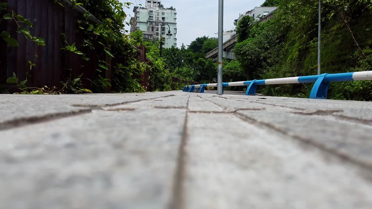 Unique low angle view of people walking passing by on worn pavement