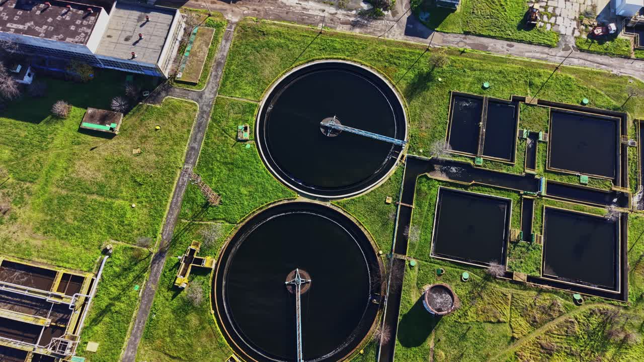 Wastewater treatment facility with circular tanks in green area
