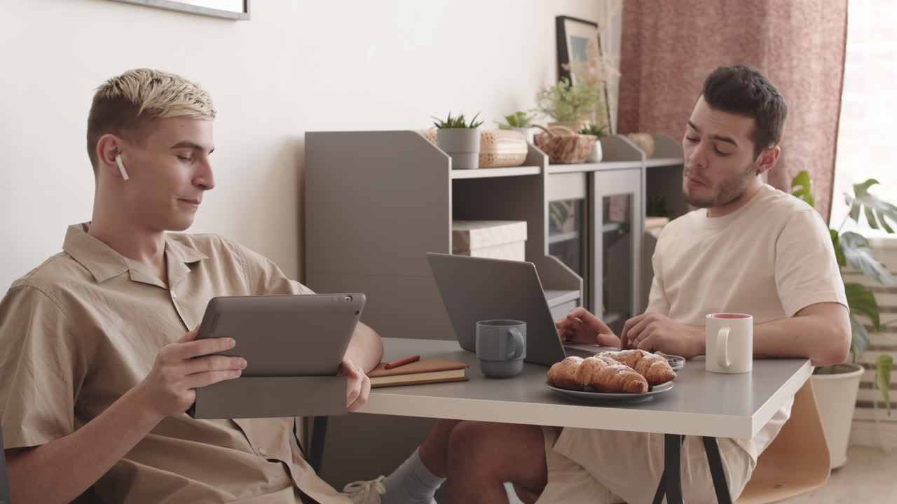 Gay Couple Using Gadgets and Having Talk at Home