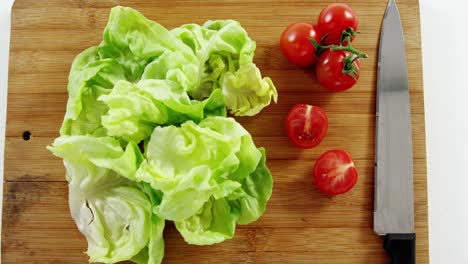 Vegetables-and-kitchen-knife-on-chopping-board