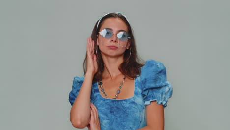 Portrait-of-seductive-pretty-young-woman-in-blue-princess-dress-wearing-sunglasses,-charming-smile