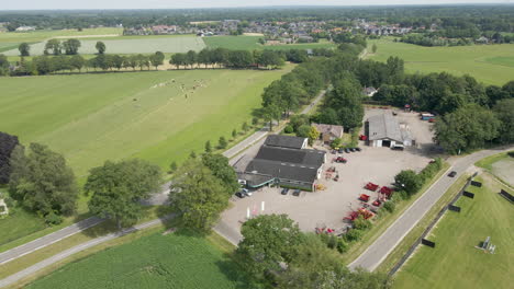 aerial orbit of agricultural company with heavy machinery on lot