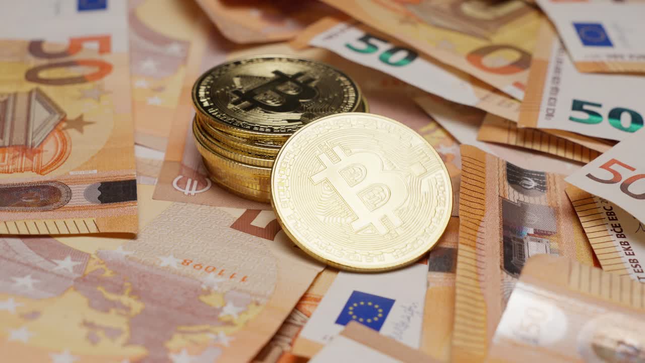 Bitcoin coins stacked on Euro banknotes, illustrating cryptocurrency and cash exchange