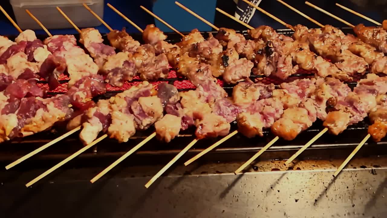 Street food vendor grilling beef in a stick on a weekend night market in Thailand
