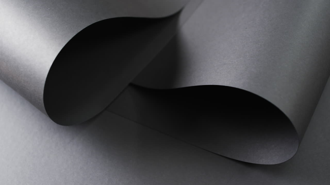 Close up of rolls of black paper and copy space on black background