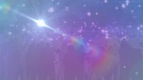 manchas brillantes de luz contra las siluetas de personas bailando