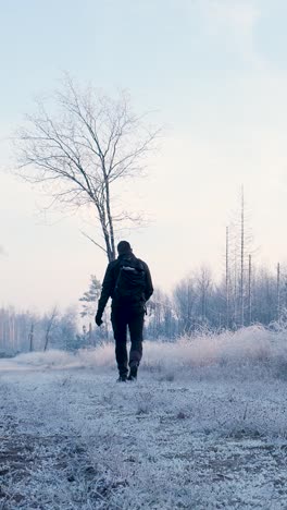 man hiking in a frozen winter landscape