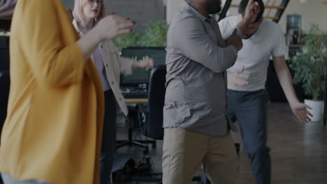 happy employees dancing in the office
