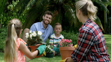 Family-having-a-discussion-while-gardening-together