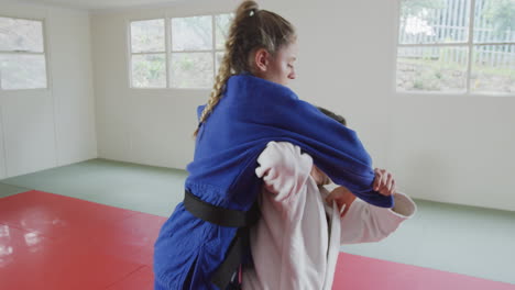 judokas training by doing a randori on the judo mat