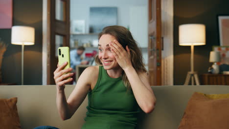 shocked woman watching cellphone at home closeup. surprised girl receiving news