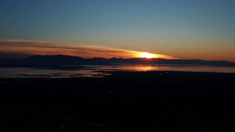 Gorgeous-aerial-drone-view-of-Utah-lake-during-a-golden-sunset-on-a-warm-fall-evening-in-Provo