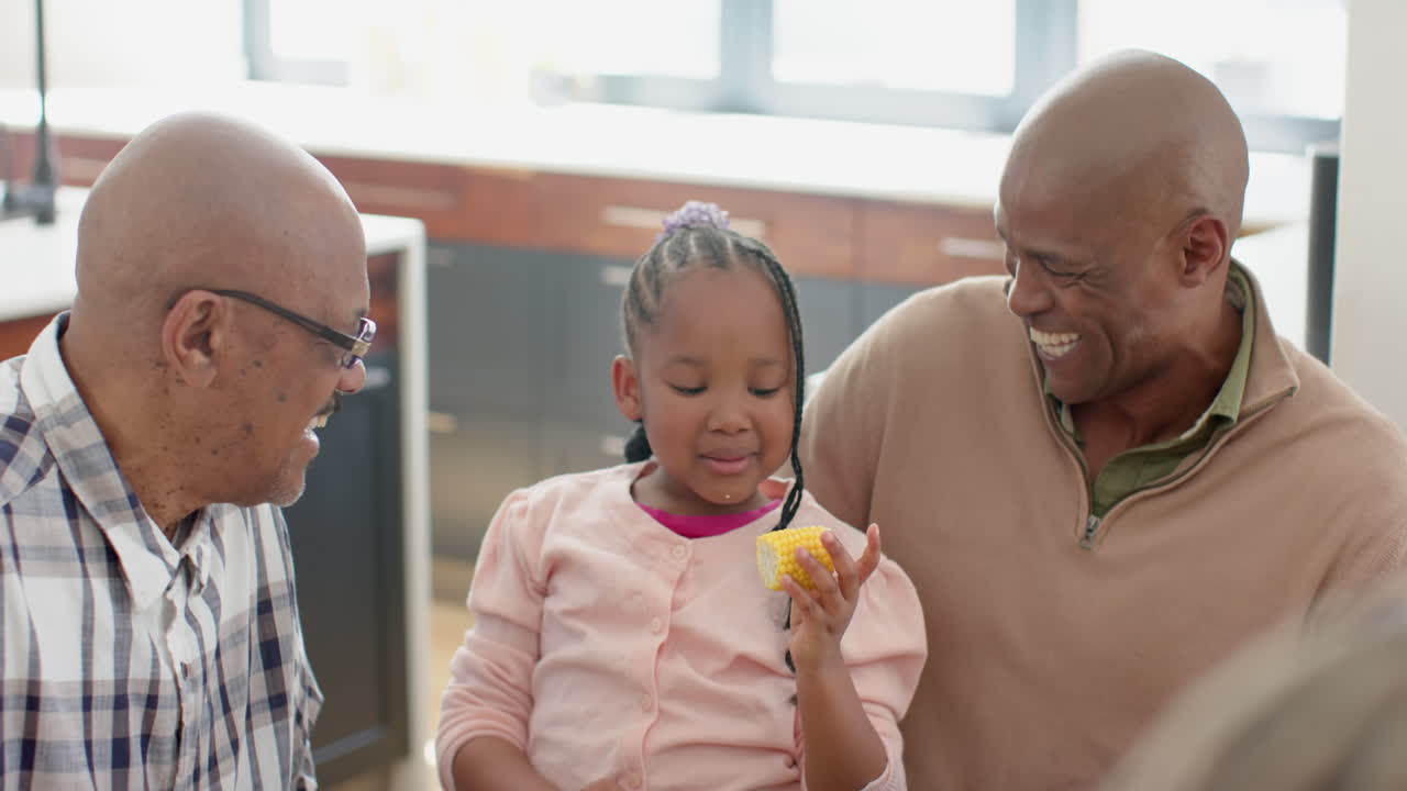 African american grandfather,father and granddaughter at thanksgiving dinner , slow motion