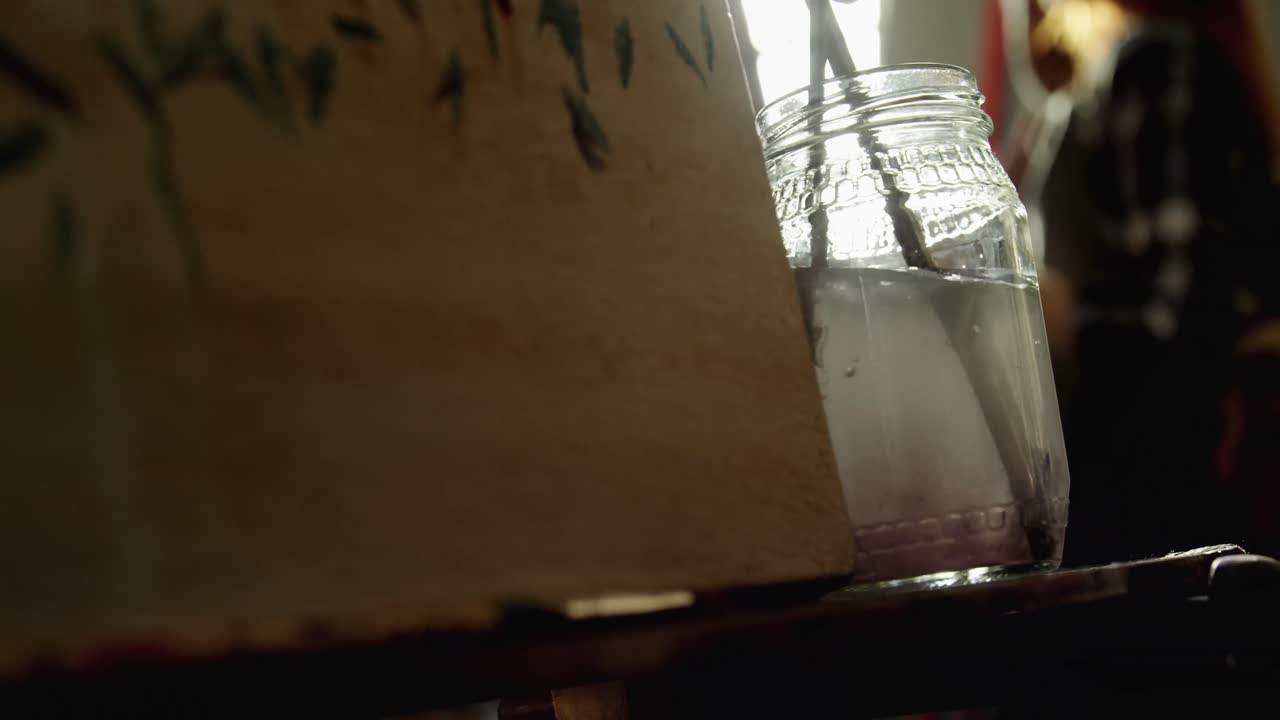 물 4k에서 페인트 브러시를 청소하는 예술가