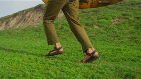 Closeup-of-a-surfer-running-for-the-beach-following-a-long-hike-to-a-remote-surf-spot