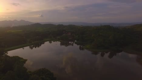 Aerial-view-of-a-lake-during-a-sunset-in-Venezuela-with-dramatic-orange-sky