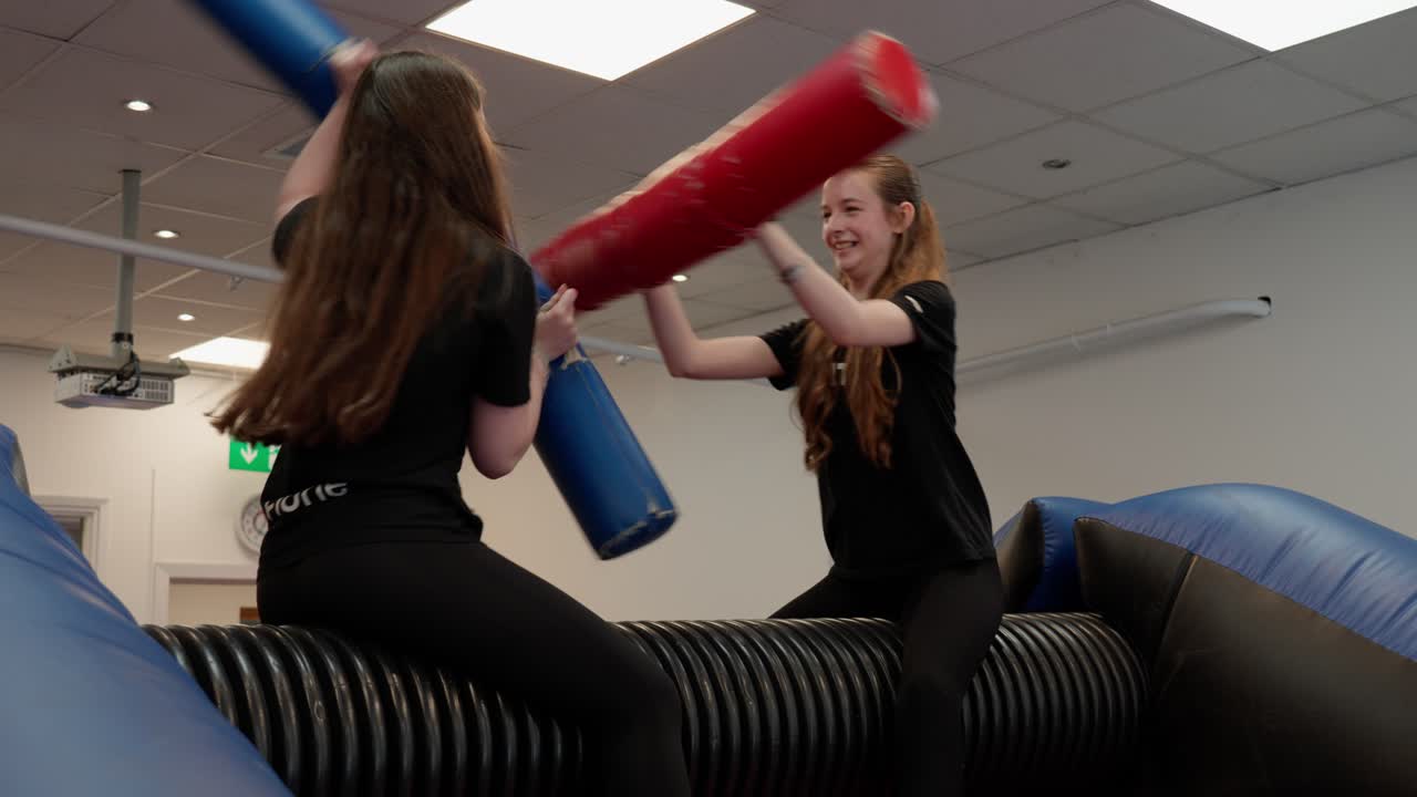Fun playful competition, balance inflatable challenges, teenage action