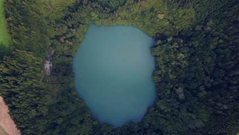 Aerial-drone-video-of-a-hidden-lake-in-the-middle-of-the-rainforest-in-Azores-volcanic-islands