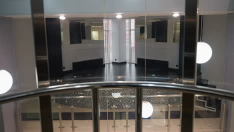 first-person perspective capturing the beautiful environment from within an elevator. the video showcases modern design elements and bright lighting, emphasizing the sleek