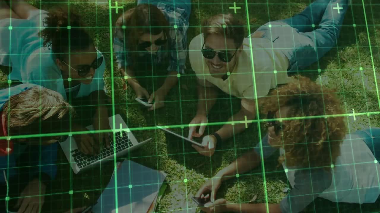 Glowing grid lines moving against group of people using electronic devices in the park