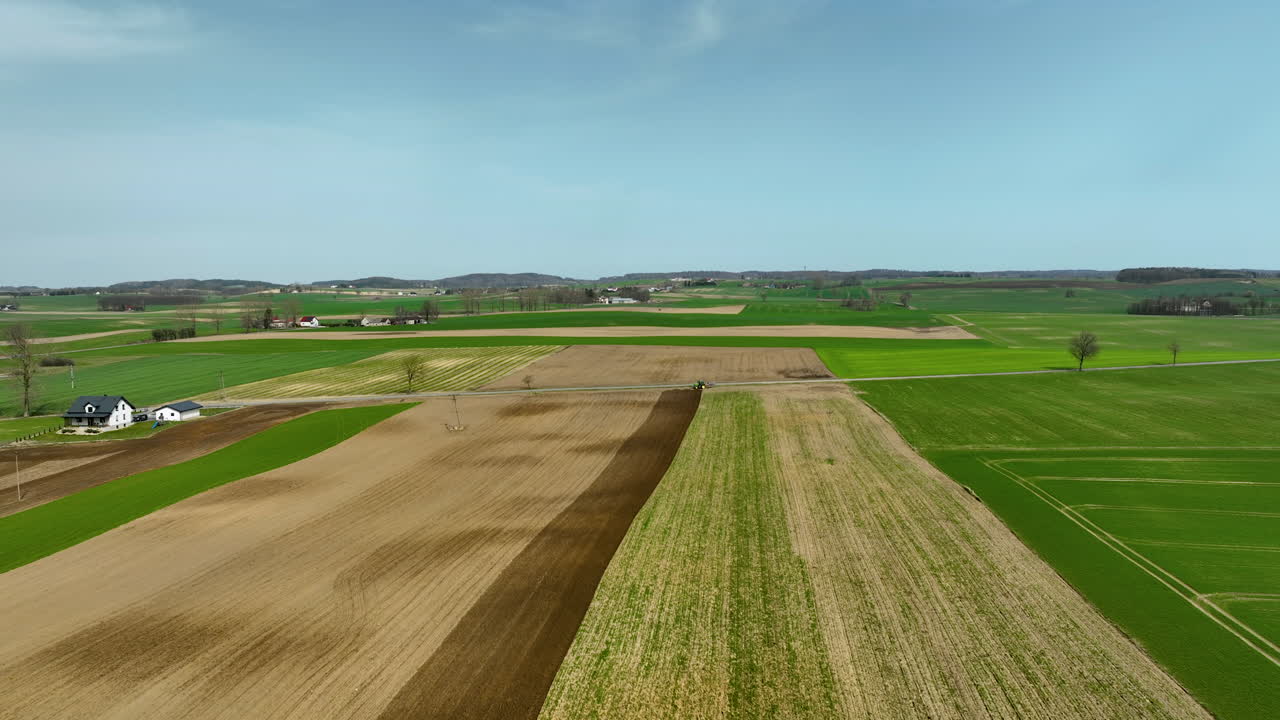 Polish Farm House in countryside with colorful fields and sunlight in spring