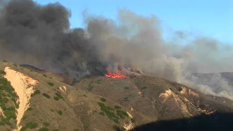 long shot of wildfires burning on a ridge in southern california