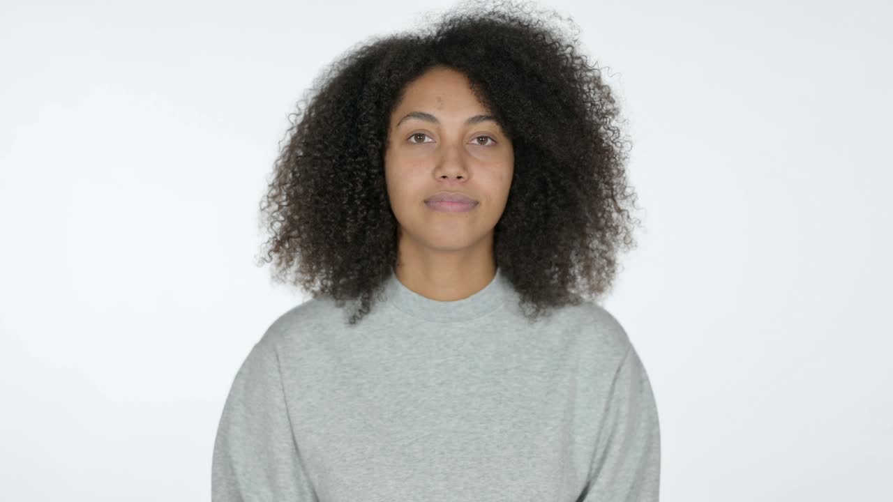 joven mujer africana dando un beso volador, fondo blanco