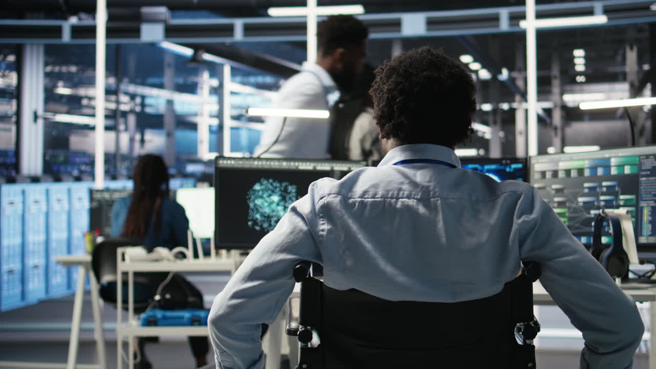 Data center programmer in wheelchair entering office uses AI node tree program