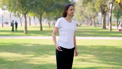 Indian-girl-stretching-legs-and-warming-up-her-body-in-a-park-in-morning