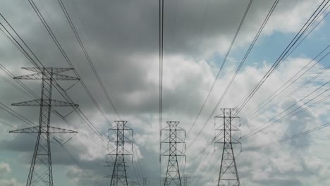 time lapse of clouds moving behind high tension wires and power lines 2