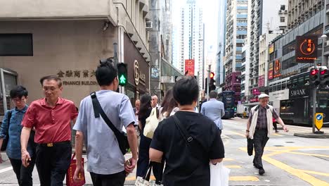 people walking across a bustling city intersection