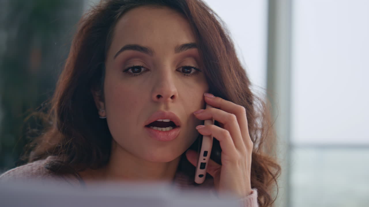 Serious consultant calling cellphone at desk closeup. Manager looking documents