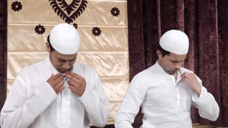 muslim men doing rituals of muslim prayer