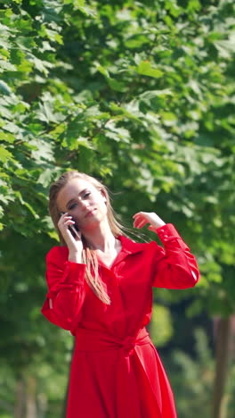 woman using smartphone outdoors. happy young woman talking on phone while walking on the street vertical video