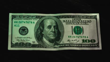 one hundred american dollar and magnifying glass. view a paper bill through a magnifying glass