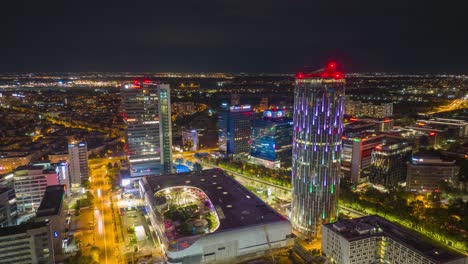 night aerial hyperlapse of illuminated cityscape with modern