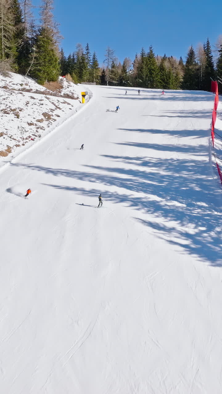 Aerial drone view of a ski resort in Piani di Pezze, Alleghe, Province of Belluno, in the Dolomites, Italy in daylight. Vertical