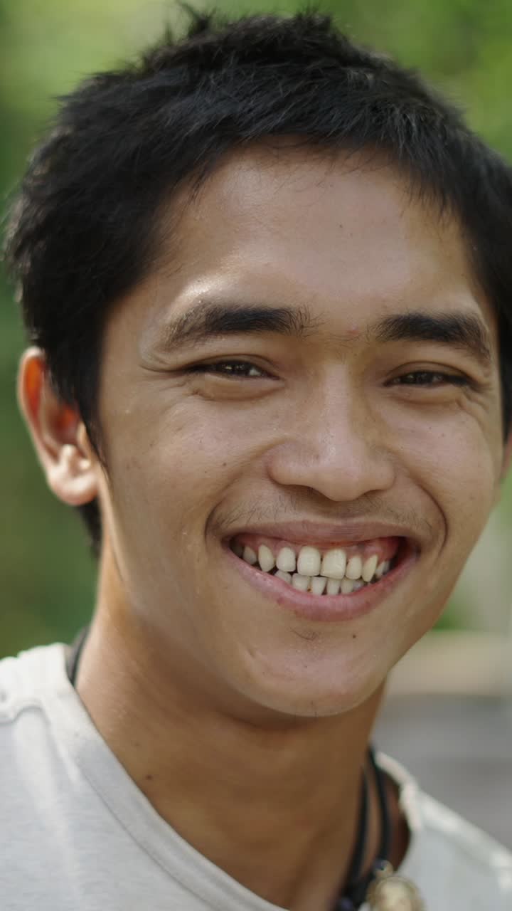 Close-up Portraits of a Young Man Smiling and Laughing