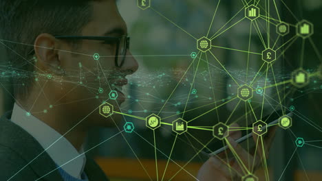 male business professional scrolling smartphone in office, displaying animated finance icons
